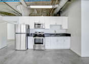 Thumbnail 39 of 92 - a kitchen with white cabinets and a stainless steel refrigerator
