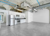 Thumbnail 40 of 92 - a kitchen with white cabinets and a stainless steel refrigerator