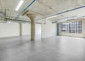 Thumbnail 45 of 92 - an empty room with a large window and concrete floors