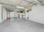 Thumbnail 42 of 92 - the interior of a large parking garage with white walls and concrete floors