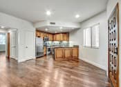 Thumbnail 31 of 88 - a kitchen and living room with hardwood floors and white walls