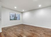 Thumbnail 77 of 88 - a room with a hardwood floor and white walls