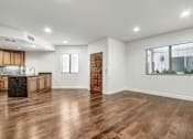 Thumbnail 71 of 88 - a kitchen and living room with hardwood floors and a large window