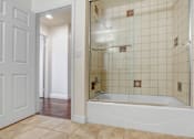Thumbnail 79 of 88 - a bathroom with white tile and a white bathtub