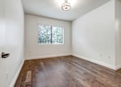 Thumbnail 76 of 88 - a bedroom with hardwood floors and white walls