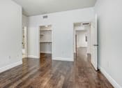 Thumbnail 73 of 88 - a bedroom with hardwood floors and white walls