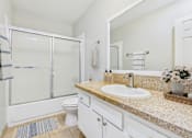 Thumbnail 20 of 65 - A bathroom with a sink, toilet, and shower.