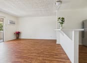 Thumbnail 8 of 46 - A room with wooden floors and white walls.