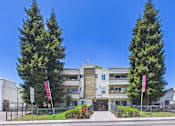 Thumbnail 1 of 46 - A modern building with a flag on the left and right side.