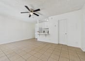 Thumbnail 26 of 46 - A room with a ceiling fan and tiled floor.