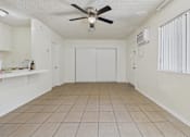 Thumbnail 24 of 46 - A room with a ceiling fan and a closed door.