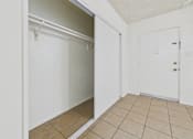 Thumbnail 22 of 46 - A white door is open to a room with a tiled floor.