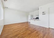 Thumbnail 32 of 46 - A room with wooden floors and white walls.