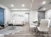 Thumbnail 22 of 42 - Living room and dining area with recessed lighting, wood style flooring throughout
