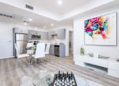 Thumbnail 1 of 42 - Modern interior of a unit with stainless steel appliances, laminate flooring throughout, recessed lighting