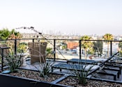 Thumbnail 20 of 46 - A balcony with a view of the city skyline at Skylar At Sunset Apartments, Los Angeles, California