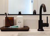 Thumbnail 36 of 46 - A white bottle of hand soap sits on a bathroom counter at Skylar At Sunset Apartments, Los Angeles