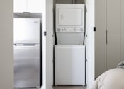 Thumbnail 39 of 46 - A white dishwasher is stacked on top of a white refrigerator at Skylar At Sunset Apartments, California, 90027