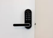 Thumbnail 23 of 46 - A black keypad is mounted on a white wall at Skylar At Sunset Apartments, Los Angeles, California