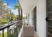 Thumbnail 24 of 28 - a balcony with a couch and a chair