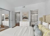 Thumbnail 23 of 28 - a bedroom with a large bed and a bathroom in the background