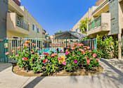 Thumbnail 28 of 40 - A flower bed in front of a building with a sign that says "Entertainment".