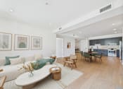Thumbnail 18 of 157 - A modern living room with a white couch and a wooden coffee table.