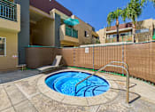 Thumbnail 22 of 40 - A small pool with a metal ladder sits in the middle of a patio.