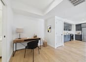 Thumbnail 17 of 157 - A room with a desk and chair in it.