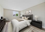 Thumbnail 4 of 77 - A bedroom with a large bed and a chair.