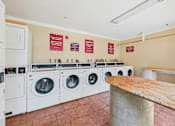 Thumbnail 37 of 40 - A row of washing machines in a public laundromat.