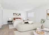 Thumbnail 27 of 81 - A modern bedroom with a large bed and a small table with a plant on it.