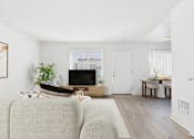 Thumbnail 25 of 81 - A living room with a grey sofa and a wooden coffee table.