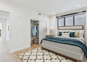 Thumbnail 11 of 157 - A bedroom with a large bed and a wardrobe.