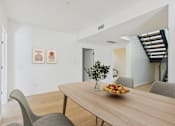 Thumbnail 5 of 157 - A dining room with a wooden table and chairs.