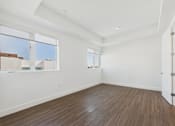 Thumbnail 40 of 45 - A room with wooden flooring and white walls.