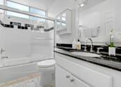 Thumbnail 8 of 28 - a white bathroom with a sink and a toilet
