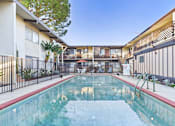 Thumbnail 22 of 23 - A pool in a courtyard surrounded by buildings.