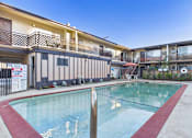 Thumbnail 23 of 23 - A swimming pool in front of apartment buildings.
