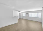 Thumbnail 83 of 95 - an empty living room with white walls and wood flooring and a ceiling fan