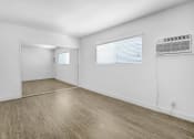 Thumbnail 84 of 95 - the living room of an empty apartment with white walls and wood floors