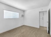 Thumbnail 87 of 95 - the living room of an apartment with white walls and wood floors