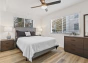 Thumbnail 28 of 66 - a bedroom with a bed and a ceiling fan