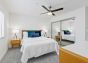 Thumbnail 34 of 66 - a bedroom with a bed and a ceiling fan