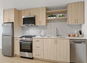 Thumbnail 23 of 54 - A modern kitchen with wooden cabinets and stainless steel appliances.