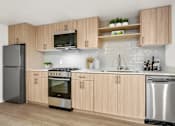 Thumbnail 45 of 54 - A modern kitchen with wooden cabinets and stainless steel appliances.