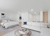 Thumbnail 29 of 54 - A modern bedroom with a large bed and a white couch.