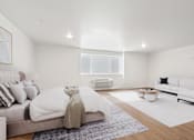 Thumbnail 37 of 54 - A modern bedroom with a large bed and a white couch.