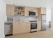 Thumbnail 38 of 54 - A kitchen with wooden cabinets and stainless steel appliances.