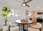 Thumbnail 1 of 54 - A modern kitchen with a round table and chairs.